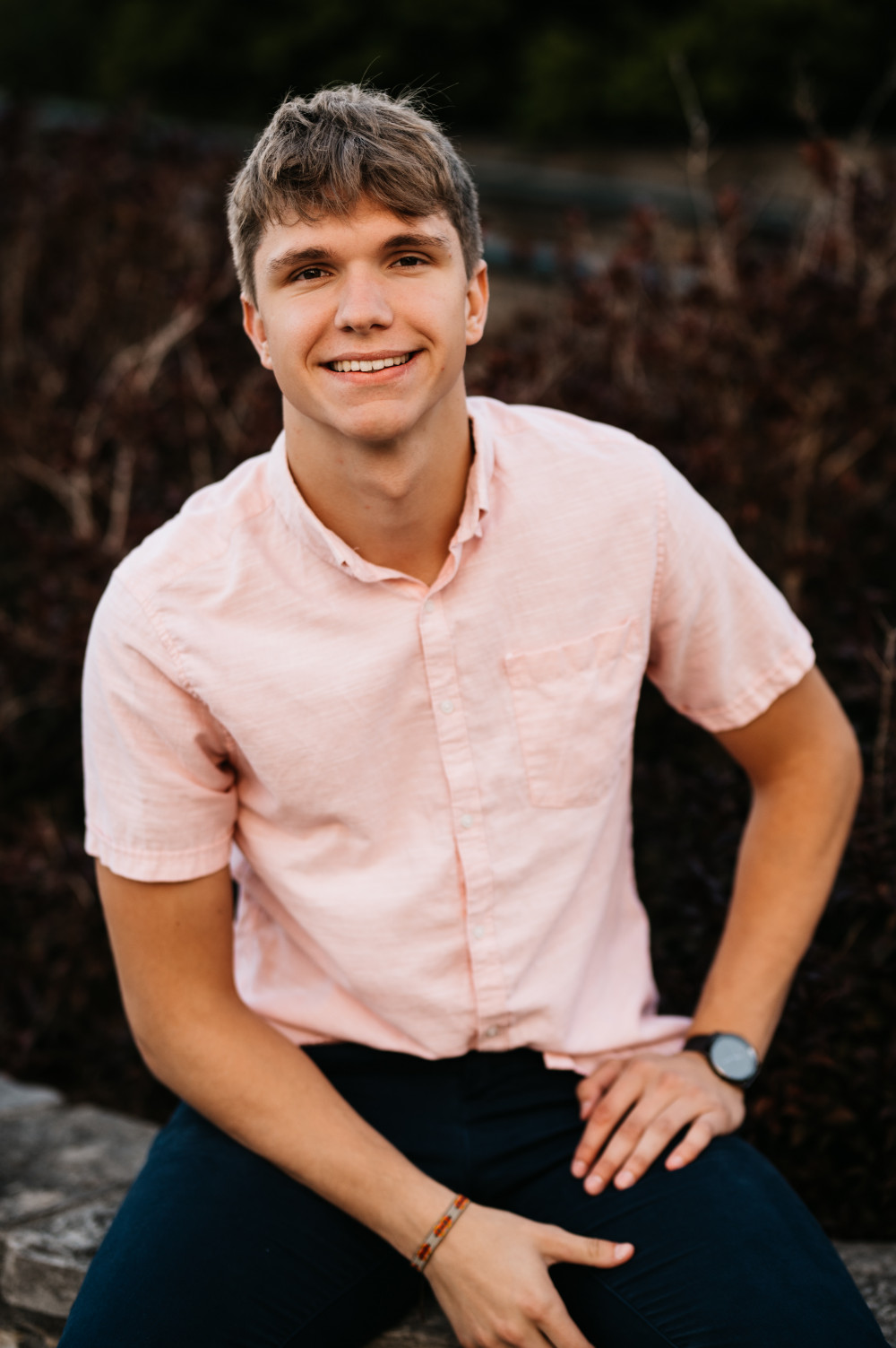 A picture of Cameron Snyder sitting on stone ledge