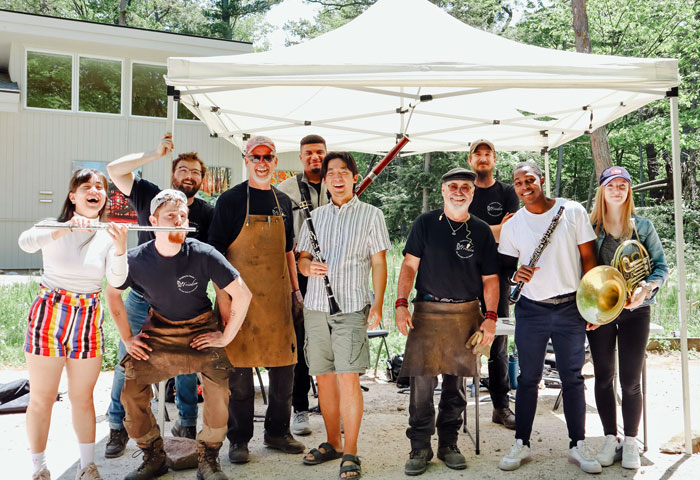 Sound Garden Quintet musicians standing for a photo with members of Forging for Peace