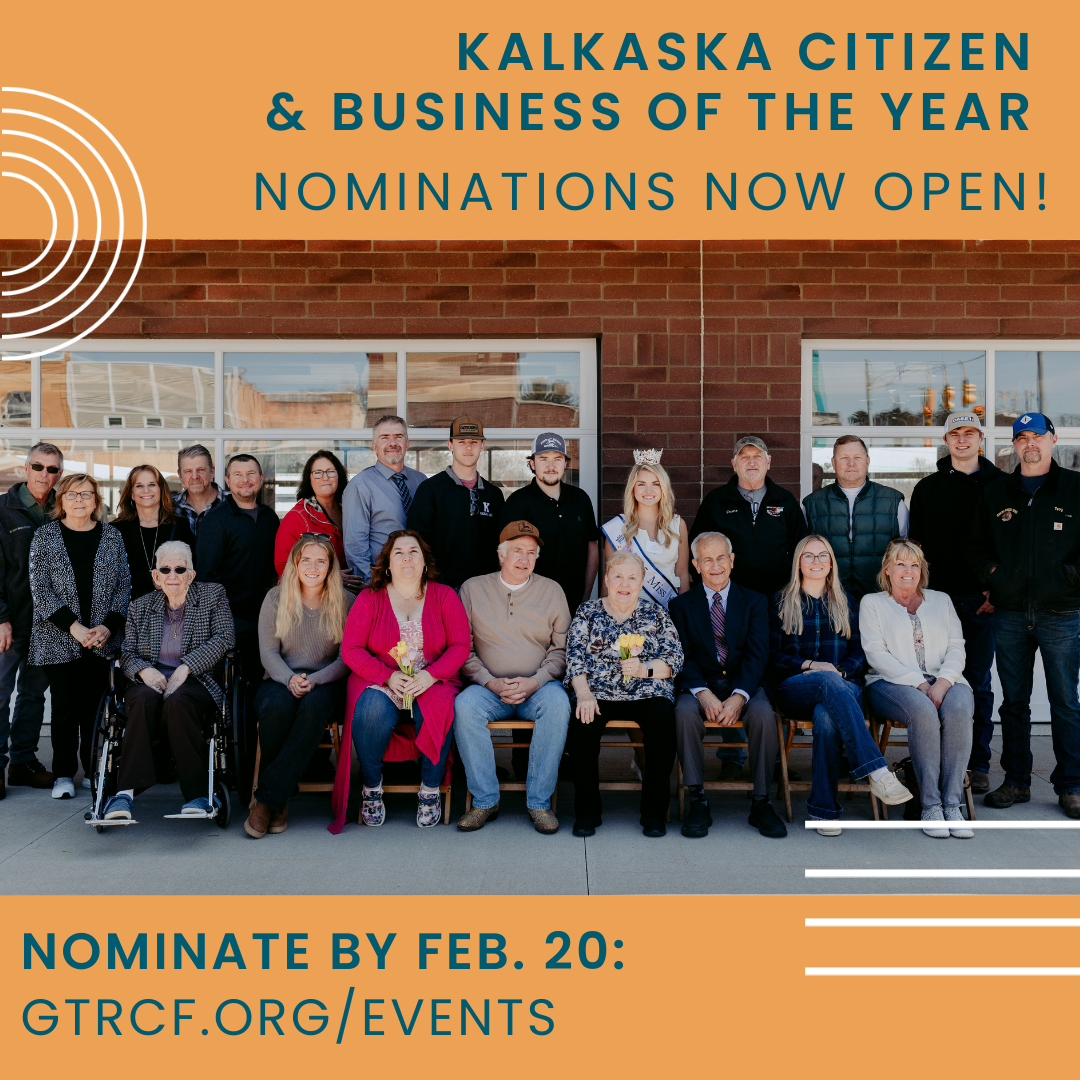 Group photo of 2025 Kalkaska Citizen and Businesses of the Year award winners seated and standing in front of a brick building with large windows